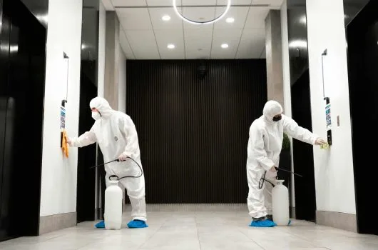 Team disinfecting elevators